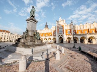 cityscape-view-on-the-market-square-with-cloth-hall-building-and-adam-mickiewicz-monument-during-the-morning-light-in-krakow-poland.jpg